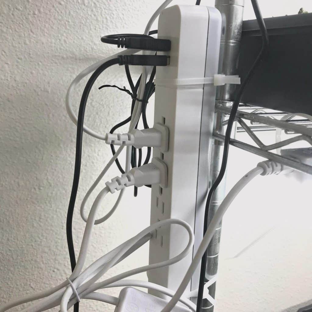 Power strip zip tied to metal rack